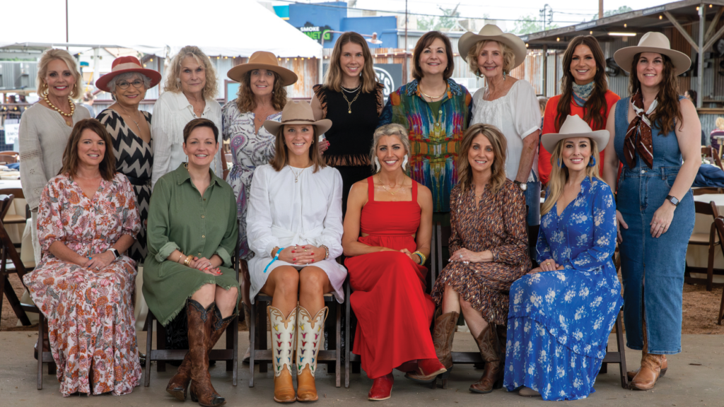 A group of women pose for a photo in two rows