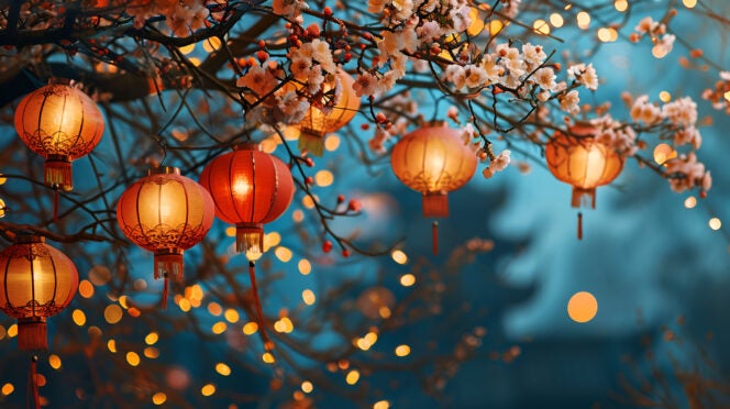 banner with place for text for chinese new year or lantern festival, glowing chinese lanterns close up on bokeh background