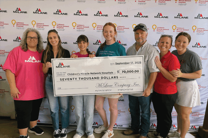 Group holding a $70,000 check for Children's Miracle Network Hospitals in front of McLane and CMN backdrop.