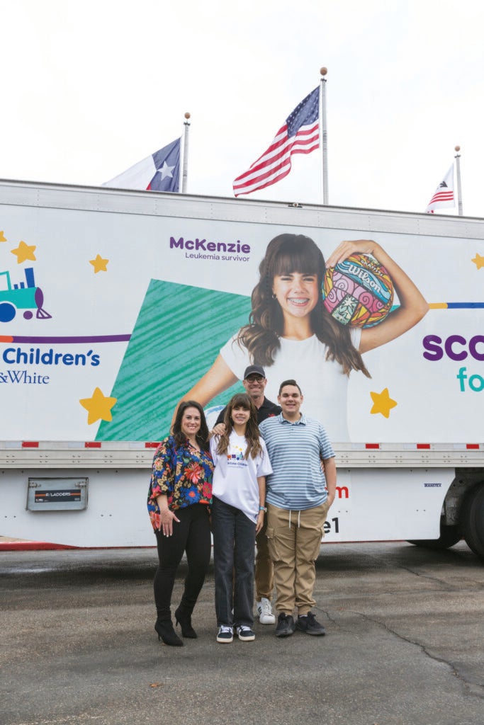 McKenzie’s family stand in front of the trailer celebrating her passions for soccer and volleyball.